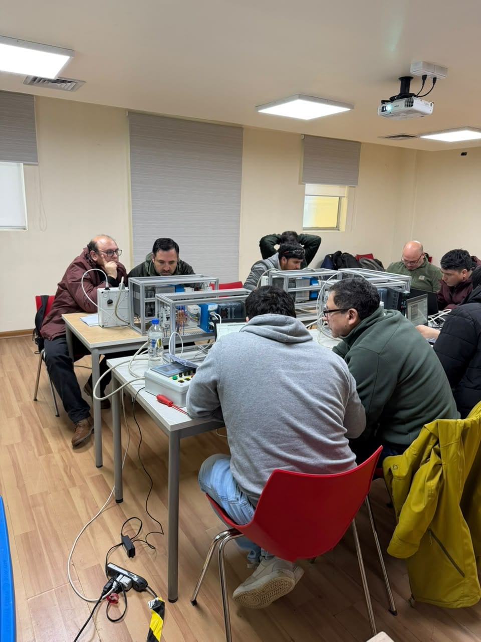 La sala durante la tercera jornada: participantes de COMASA trabajando en grupos sobre las maletas de entrenamiento
